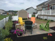 Colorful landscaping  around hardscaped patio Installed by Aaron of Landscape Solutions. Rochester NY. 14616

585-342-5296