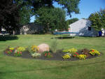 Landscaped island with flowers and plants. Installed by Aaron of Landscape Solutions. Rochester NY. 14616

585-342-5296